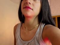 A brunette girl with soft, radiant skin, a slim body that moves with grace and energy. Her black, straight, shiny hair falls in soft waves over her shoulders, highlighting her lively face. She has a warm and contagious smile that lights up her expression and reflects her cheerful and laughing personality. Her attitude is determined and confident, always with a spark of confidence that is noticeable in her bearing and the way she interacts with others. She has a lively look that shows her enthusiasm for life, leaving an impression of freshness and positivity wherever she goes.